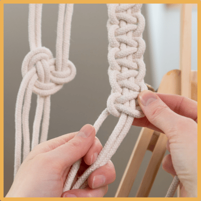 Person tying macrame knots.