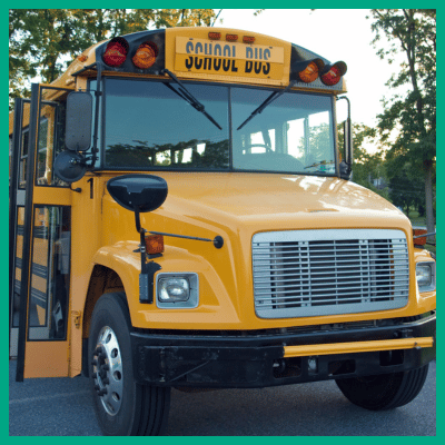 Front of a school buss with the doors open.